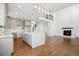 Open-concept kitchen with island, modern light fixtures, and seamless flow into the living area at 49601 E 56Th Ave, Bennett, CO 80102