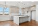 Bright open kitchen with gray cabinetry, stainless steel appliances, large island and scenic views at 49601 E 56Th Ave, Bennett, CO 80102