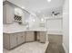 Home wet bar with shaker cabinets, wine rack, marble backsplash, and marble tile floors at 49601 E 56Th Ave, Bennett, CO 80102