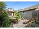 Landscaped backyard featuring a pergola, garden beds, and pathway leading to a relaxing outdoor space at 815 S Gaylord St, Denver, CO 80209