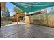 Spacious stone backyard patio with an open gate, pergola, and partially shaded area at 815 S Gaylord St, Denver, CO 80209