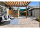 Inviting backyard patio with a pergola, stylish outdoor seating, and decorative blue rug for relaxing and entertaining at 815 S Gaylord St, Denver, CO 80209