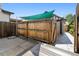 Fenced backyard with patio area and sunshade, perfect for outdoor gatherings at 815 S Gaylord St, Denver, CO 80209