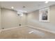 Finished basement offers versatile space with carpeted floors and natural light from updated windows at 815 S Gaylord St, Denver, CO 80209