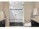 The bathroom features a frameless glass shower and updated white tile and a dark stone shower floor at 815 S Gaylord St, Denver, CO 80209