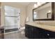 Updated bathroom features a glass shower, granite countertop, and a dark wood vanity cabinet at 815 S Gaylord St, Denver, CO 80209