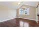 An empty bedroom with hardwood floors, a ceiling fan, and a bright window providing natural light at 815 S Gaylord St, Denver, CO 80209