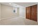 Finished basement bedroom with neutral carpet, closet with sliding doors, and window at 815 S Gaylord St, Denver, CO 80209