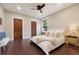 Bright bedroom featuring hardwood floors, a ceiling fan, and light neutral wall paint at 815 S Gaylord St, Denver, CO 80209