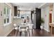 Bright dining area with modern chairs, hardwood floors, and open to kitchen at 815 S Gaylord St, Denver, CO 80209