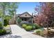 Inviting home with a well-manicured lawn, mature trees, and a concrete driveway at 815 S Gaylord St, Denver, CO 80209