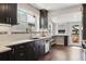 Modern kitchen with dark cabinets, light countertops, and stainless steel appliances at 815 S Gaylord St, Denver, CO 80209