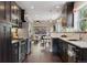 An open layout kitchen and dining area with stainless steel appliances and hardwood floors at 815 S Gaylord St, Denver, CO 80209