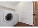 Bright laundry area featuring a modern washer and dryer set and shelving at 815 S Gaylord St, Denver, CO 80209