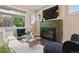 Bright living room featuring a fireplace, neutral color palette, and large windows with a green view at 815 S Gaylord St, Denver, CO 80209