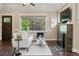 Bright living room featuring a fireplace, hardwood floors, and a large window at 815 S Gaylord St, Denver, CO 80209