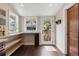Bright mud room with wooden shelves, a door to the backyard, and dark stained wood floor at 815 S Gaylord St, Denver, CO 80209