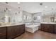 Bright bathroom features dual vanities, a soaking tub, and sleek fixtures at 230 Hudson St, Denver, CO 80220