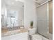 Well-lit bathroom featuring granite countertops, and a shower/tub combo with glass door at 230 Hudson St, Denver, CO 80220