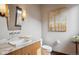 Powder room featuring marble countertop, modern sink, decorative lighting, and wood accents at 230 Hudson St, Denver, CO 80220