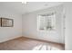 Bright basement bedroom with carpeted floors, a large window, and a neutral color palette at 230 Hudson St, Denver, CO 80220