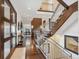 Inviting foyer with hardwood floors, soaring ceilings, and a staircase with metal railings at 230 Hudson St, Denver, CO 80220