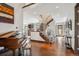 Grand foyer with hardwood floors, staircase with metal railing, piano and fireplace beyond at 230 Hudson St, Denver, CO 80220