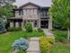 Charming two-story stone home featuring a lush front yard and a welcoming entrance at 230 Hudson St, Denver, CO 80220