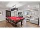 Basement game room with a striking red pool table, comfortable seating, and modern lighting at 230 Hudson St, Denver, CO 80220