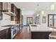 Bright kitchen featuring stainless steel appliances, a center island with seating and hardwood floors at 230 Hudson St, Denver, CO 80220