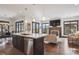 Open kitchen with stainless steel appliances, island with seating, and access to the living area at 230 Hudson St, Denver, CO 80220