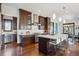Modern kitchen with a large island, dark wood cabinetry, and stainless steel appliances at 230 Hudson St, Denver, CO 80220