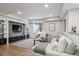 Basement living room featuring a cozy sectional sofa, built-in shelving, and a stylish gray color scheme at 230 Hudson St, Denver, CO 80220