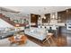 Open-concept living space showcasing hardwood floors, staircase, and a modern kitchen with a breakfast bar at 230 Hudson St, Denver, CO 80220