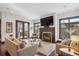 Well-lit living room with hardwood floors, comfortable seating, fireplace, and access to the outdoors at 230 Hudson St, Denver, CO 80220