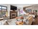 Inviting living room featuring a stone fireplace, large windows, and hardwood flooring at 230 Hudson St, Denver, CO 80220