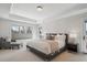 A light-filled main bedroom features a large bed and an adjacent seating area at 230 Hudson St, Denver, CO 80220