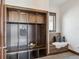 Mudroom with built-in wooden cabinets, storage cubbies, hooks, and a cozy bench with a cushioned seat at 230 Hudson St, Denver, CO 80220