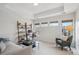 Bright home office featuring a modern sofa, desk, shelving and natural light at 230 Hudson St, Denver, CO 80220