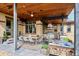 Inviting outdoor patio featuring a dining area, built-in grill, bar and comfortable seating for relaxing and entertaining at 230 Hudson St, Denver, CO 80220