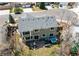 Aerial view of a home, showcasing its backyard patio with outdoor furniture and a hot tub in a suburban neighborhood at 18995 E Bellisario Creek Pl, Parker, CO 80134