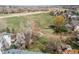 Expansive backyard with a grassy area, mature trees, and a wooden fence, providing a private outdoor space at 18995 E Bellisario Creek Pl, Parker, CO 80134