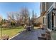 Backyard patio with a table, chairs, and ample space for outdoor gatherings, surrounded by a well-maintained lawn at 18995 E Bellisario Creek Pl, Parker, CO 80134