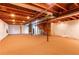 Spacious unfinished basement featuring a large open layout with carpet flooring and exposed ceiling beams, perfect for customization at 18995 E Bellisario Creek Pl, Parker, CO 80134