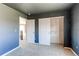 Comfortable bedroom with neutral carpet, and an open closet at 18995 E Bellisario Creek Pl, Parker, CO 80134