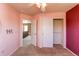 Bedroom features neutral carpeting, a ceiling fan, and closet space at 18995 E Bellisario Creek Pl, Parker, CO 80134