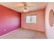 The bedroom features neutral carpet, and a large window bringing in plenty of natural light at 18995 E Bellisario Creek Pl, Parker, CO 80134
