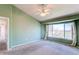 A bright bedroom is naturally lit by a large picture window with an installed ceiling fan at 18995 E Bellisario Creek Pl, Parker, CO 80134