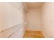 Walk-in closet features built-in shelving and neutral carpeting at 18995 E Bellisario Creek Pl, Parker, CO 80134
