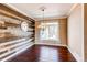 Elegant dining room with a wood accent wall, a chandelier, and hardwood floors, creating an inviting atmosphere at 18995 E Bellisario Creek Pl, Parker, CO 80134